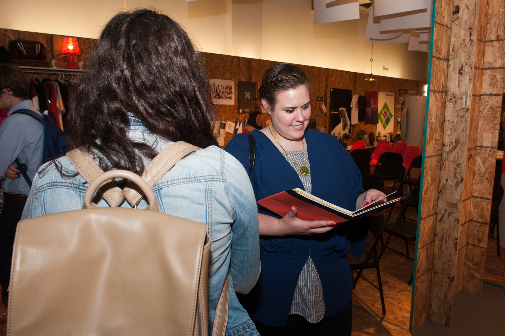 An attendee looks at his copy of the Maker's Field Guide