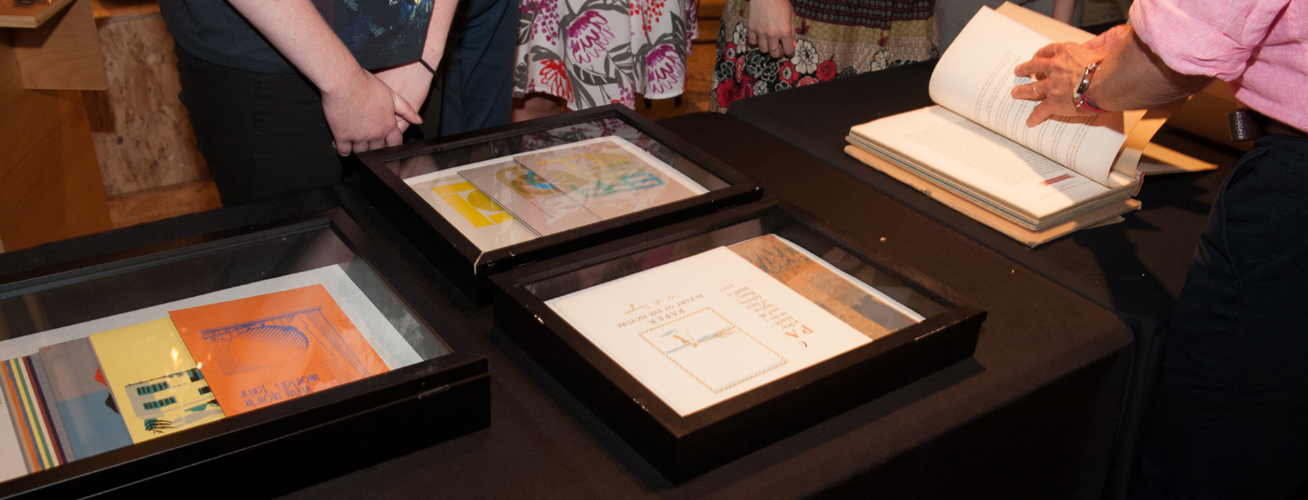 Candid image of Mohawk's Chris Harrold showing visitors samples from the archive