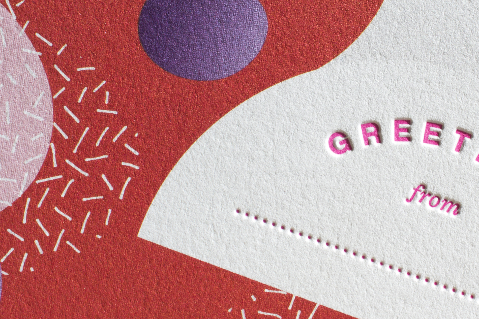 Close-up of red, pink, and purple design and typography