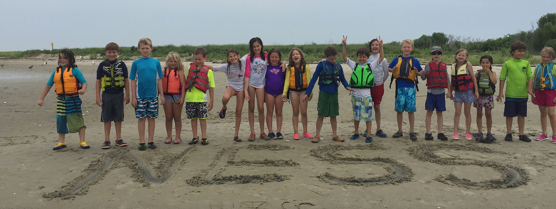 A picture of New England Science & Sailing members on a beach