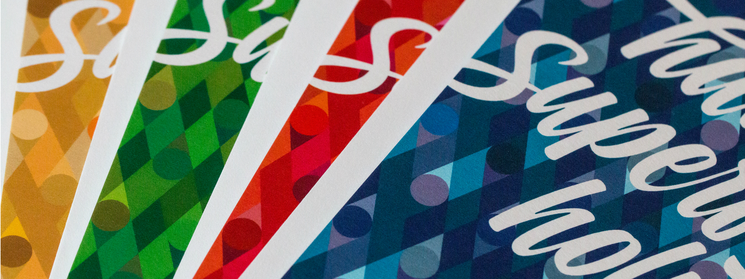 Close-up of four different colorways of the holiday card from 2015