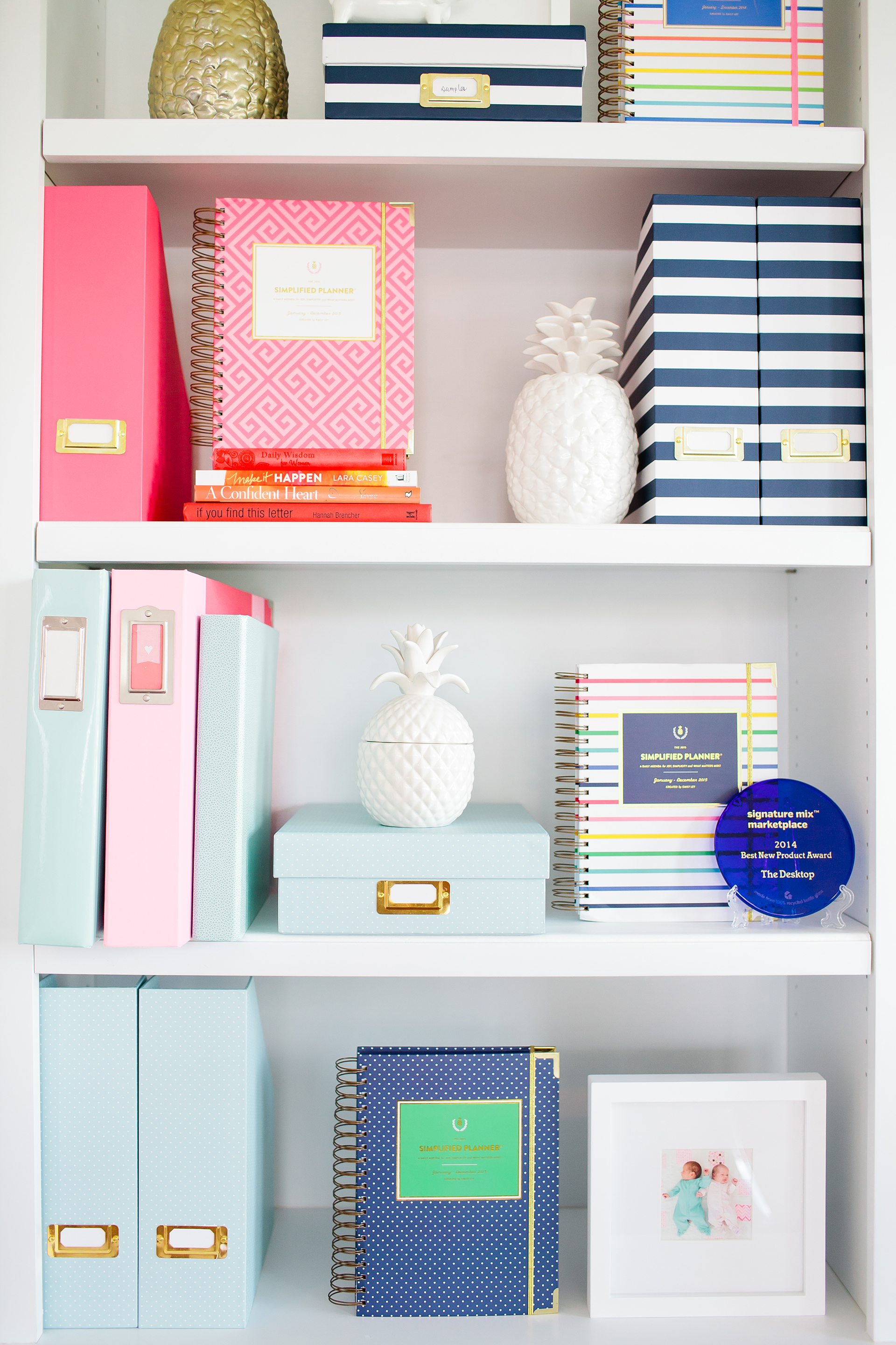 A shelf full of colorful books and objects