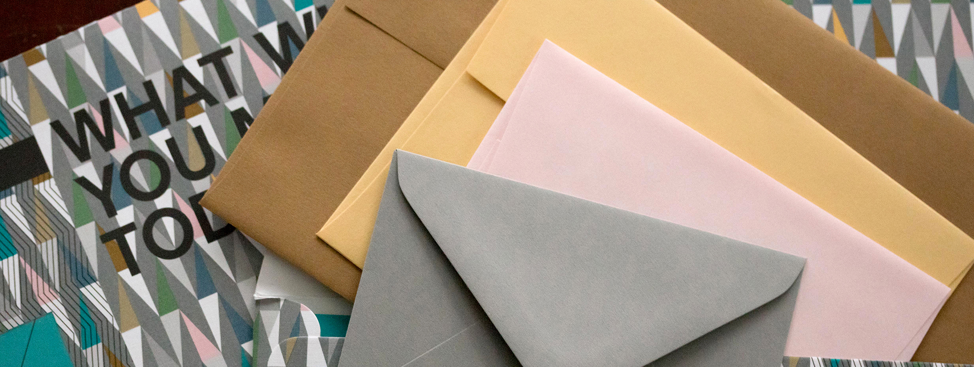 Close-up of a stack of envelopes in various sizes and colors