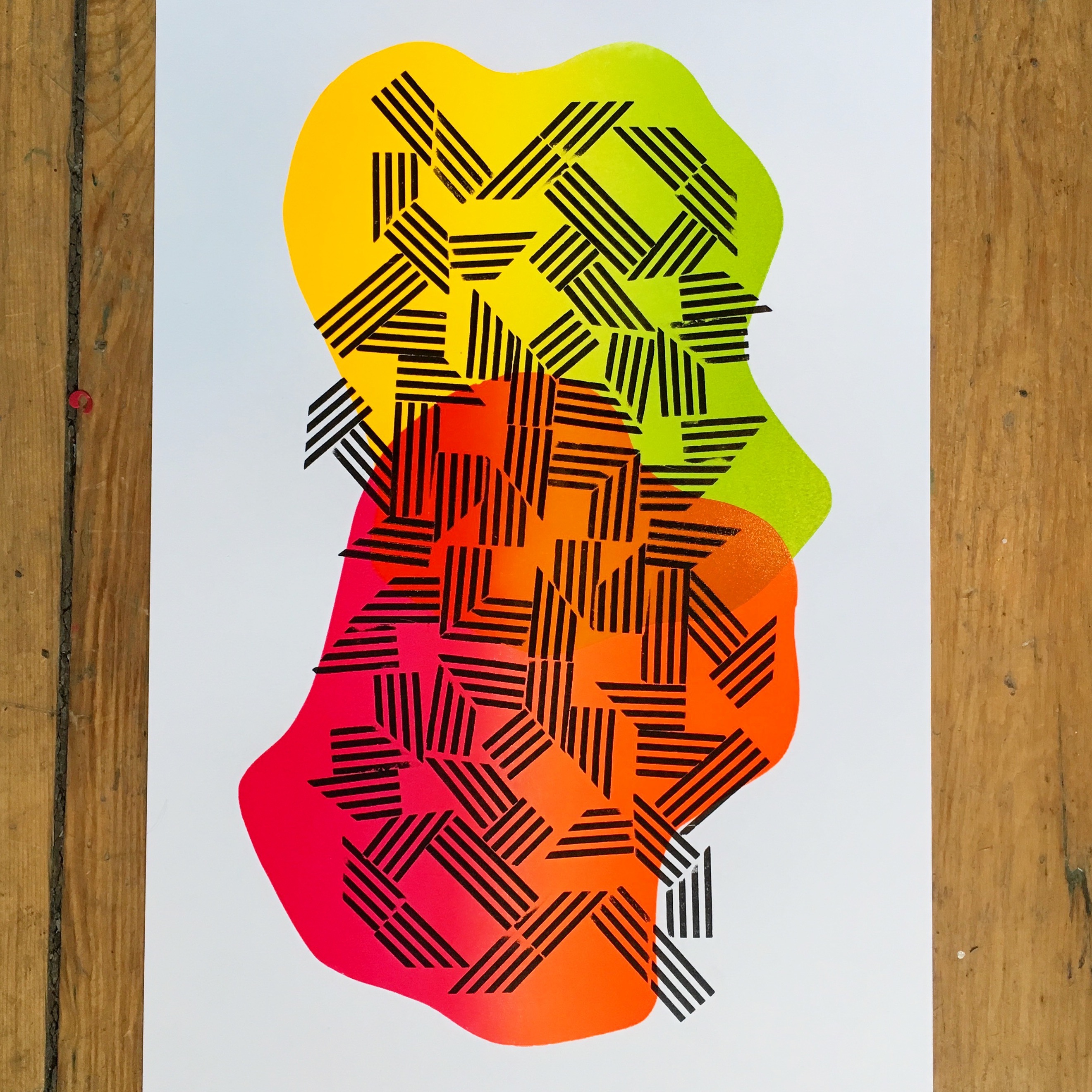 A print featuring day-glo shapes with geometric black overlay