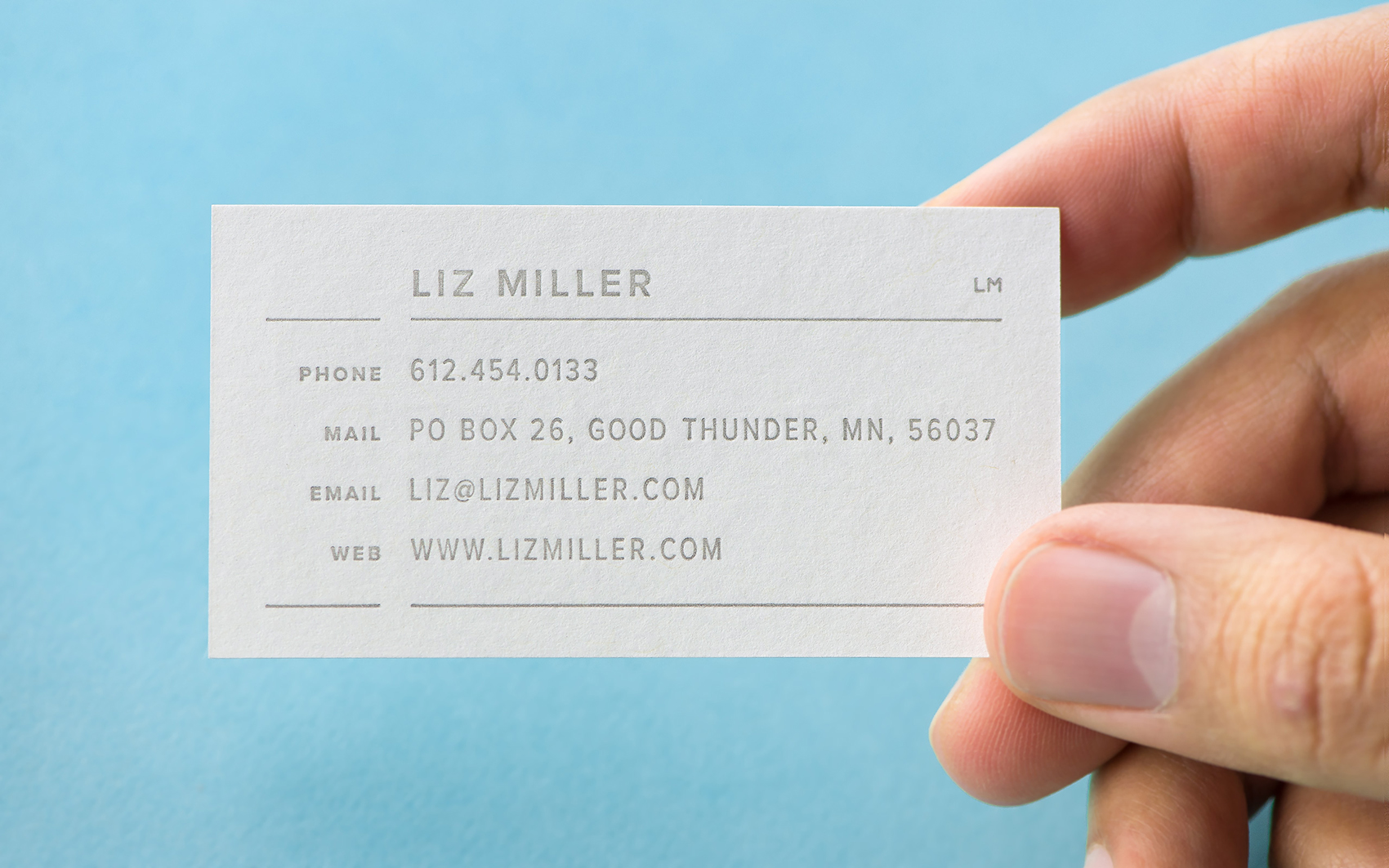 Liz Miller business card in a hand