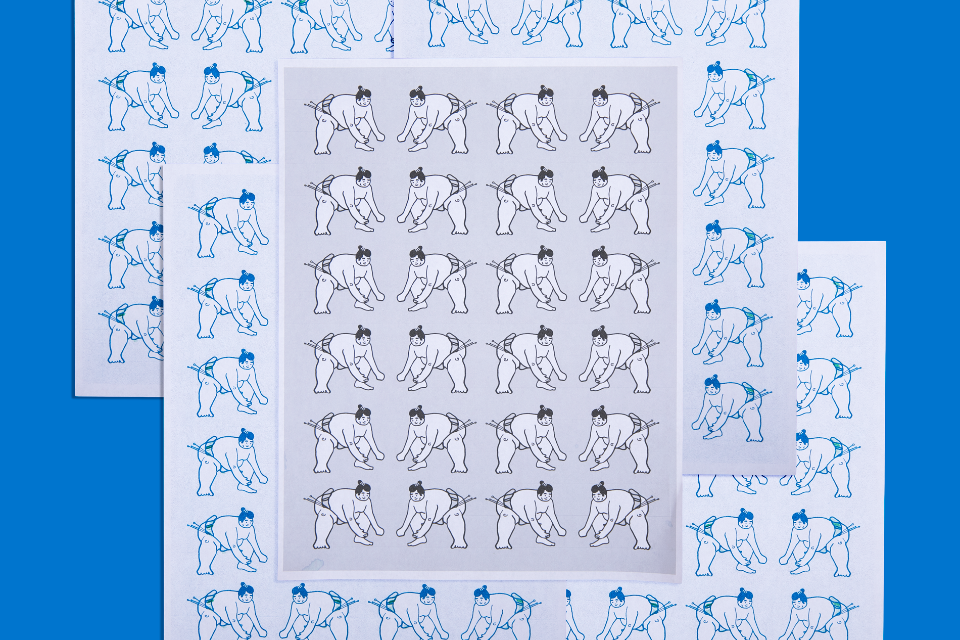 Risograph prints arranged on top of one another on a blue background