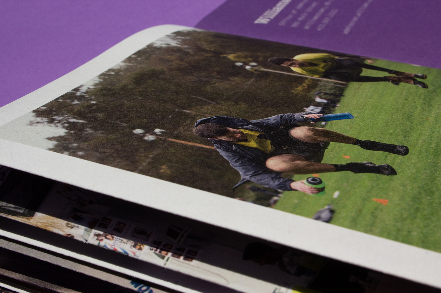 Side view of a college viewbook with a bright photo of athletes