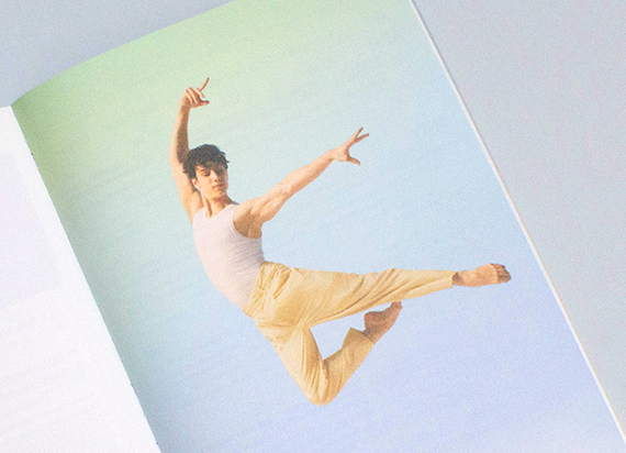 Photograph from inner spread of a ballet dancer leaping 