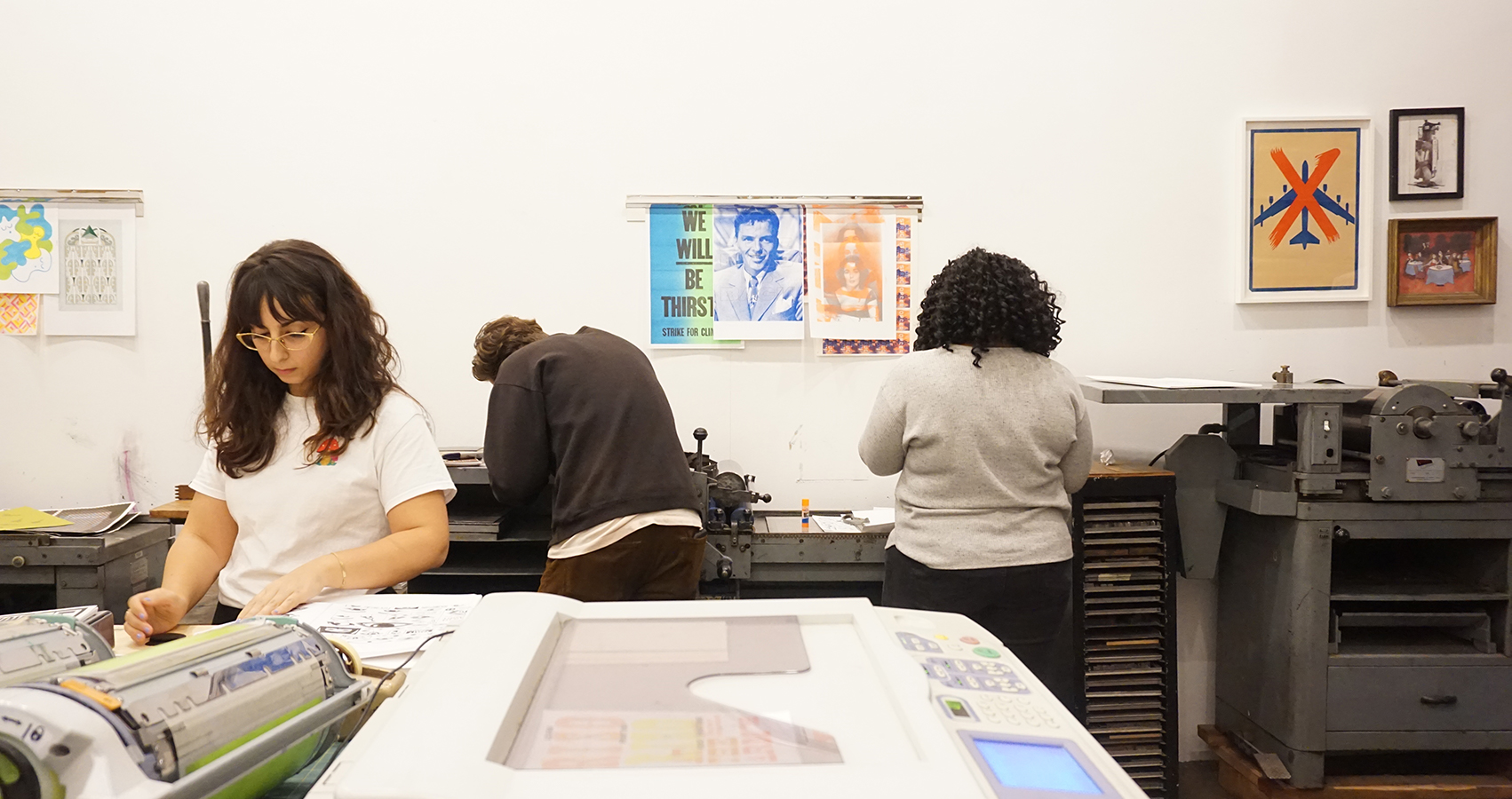 Wide shot of attendees working on their prints