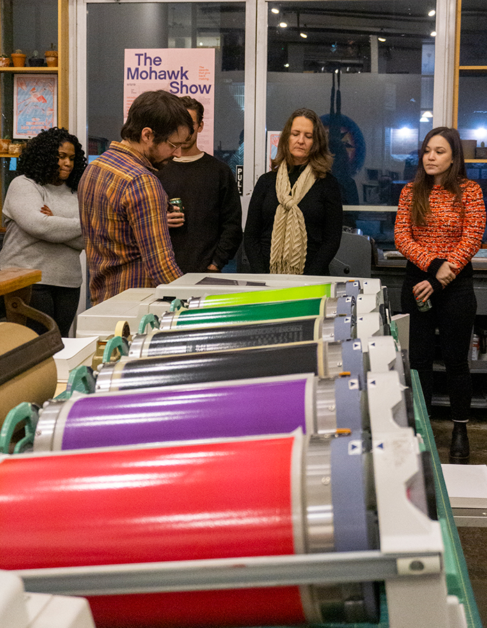 Attendees looking at a variety of posters on a table