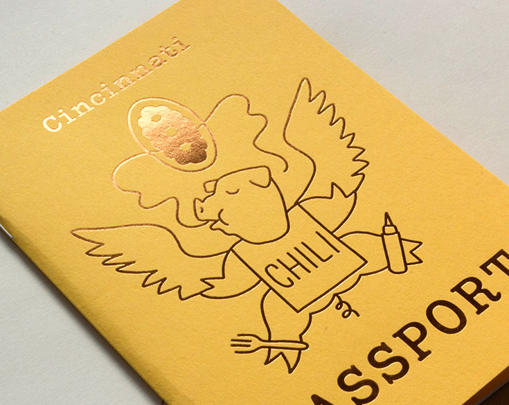 close-up of gold foil on yellow cover of chili passport