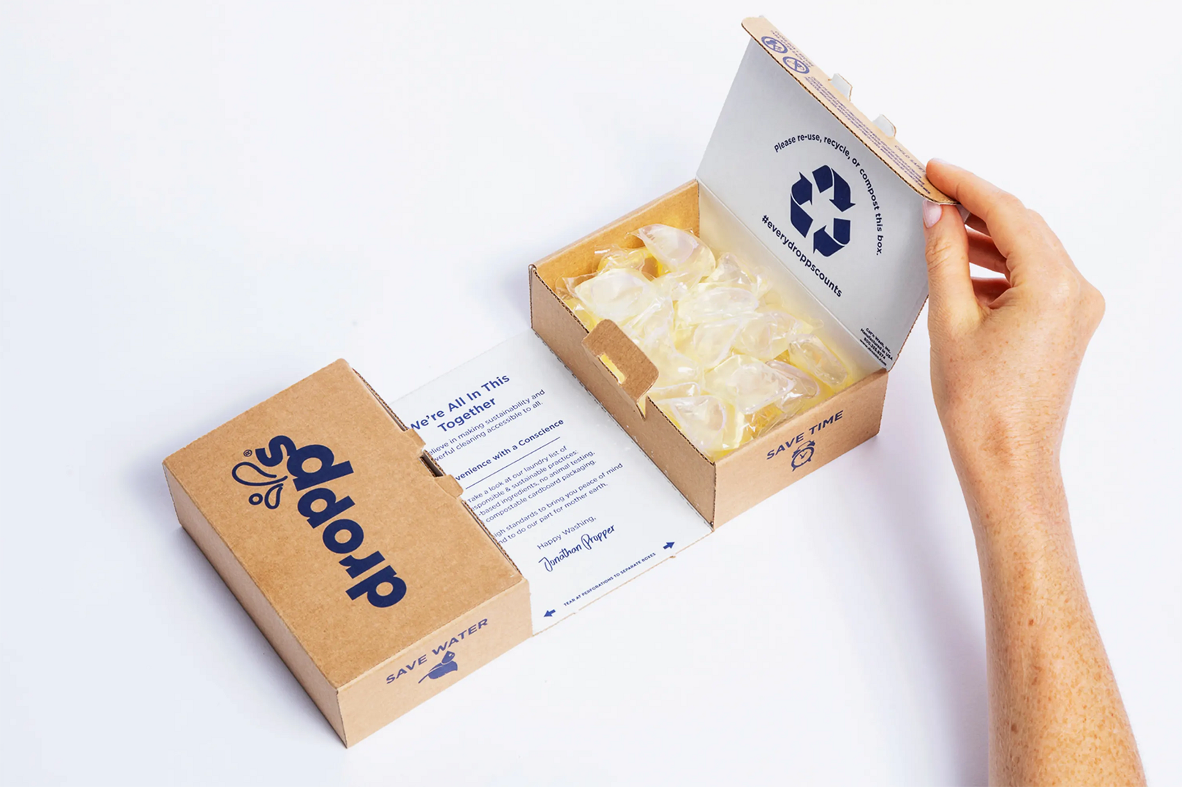 a hand opening a Dropps box
