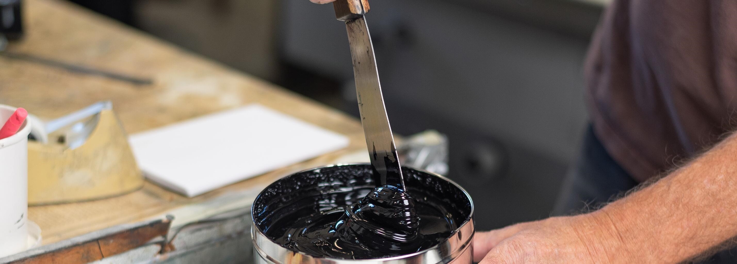 Photograph of a printer with a can of eco-friendly ink at a table