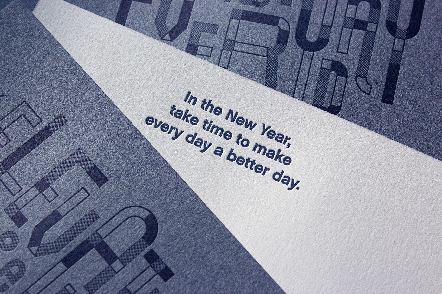 Three Elevate the Everyday holiday cards, one flipped over to show the message on the back