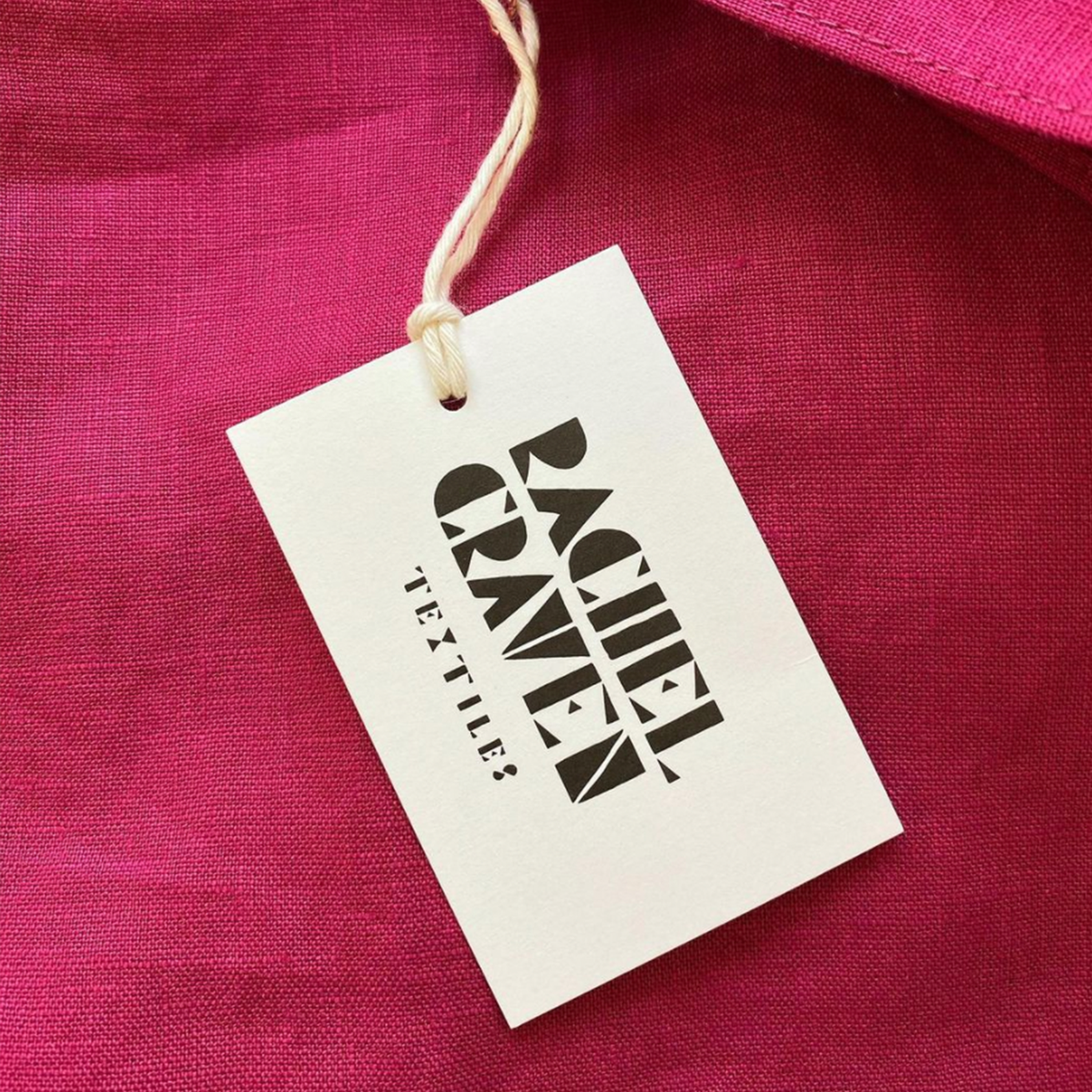 Hangtag from a Rachel Craven product on a magenta background