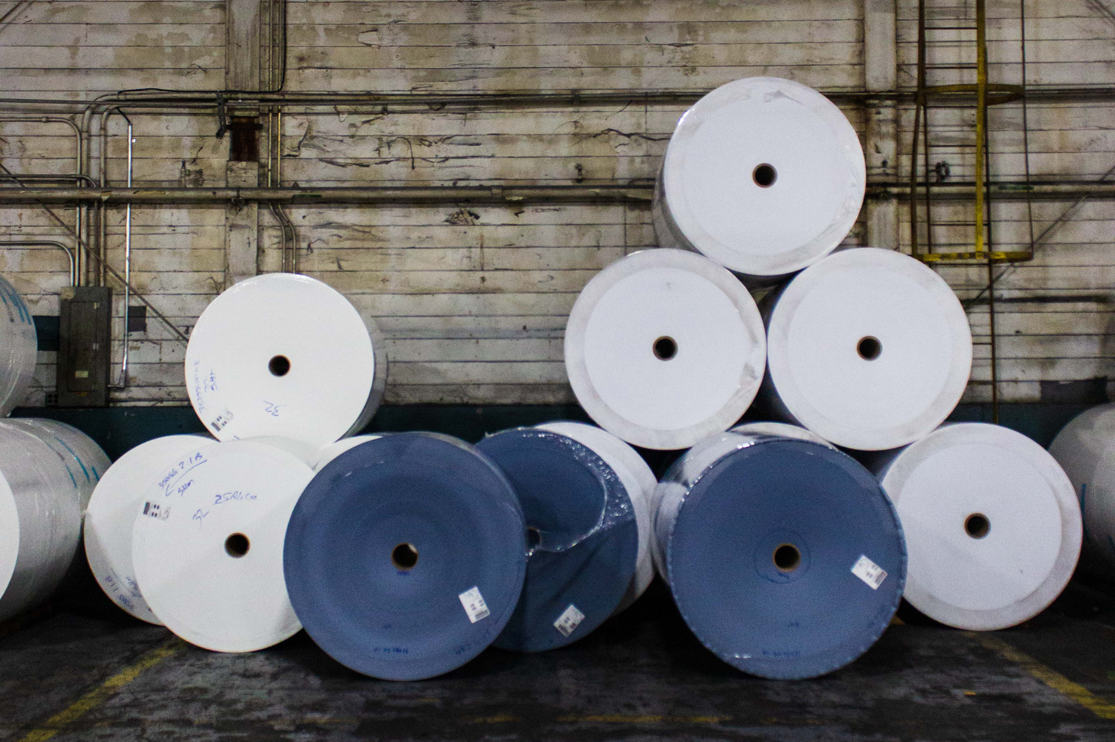 rolls of cotton paper in the warehouse in white and denim shades