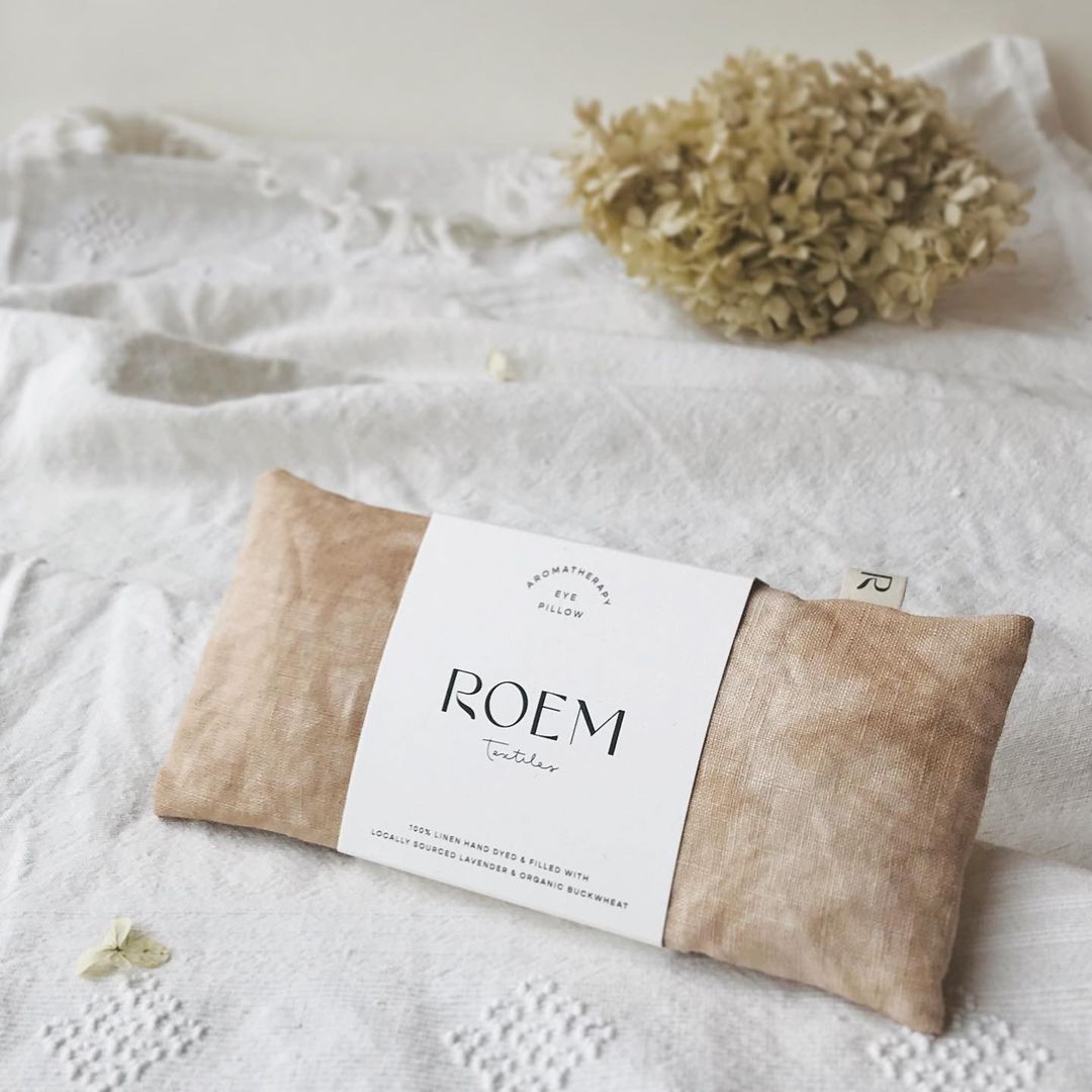 A package of Roem Textiles photographed on a linen cloth