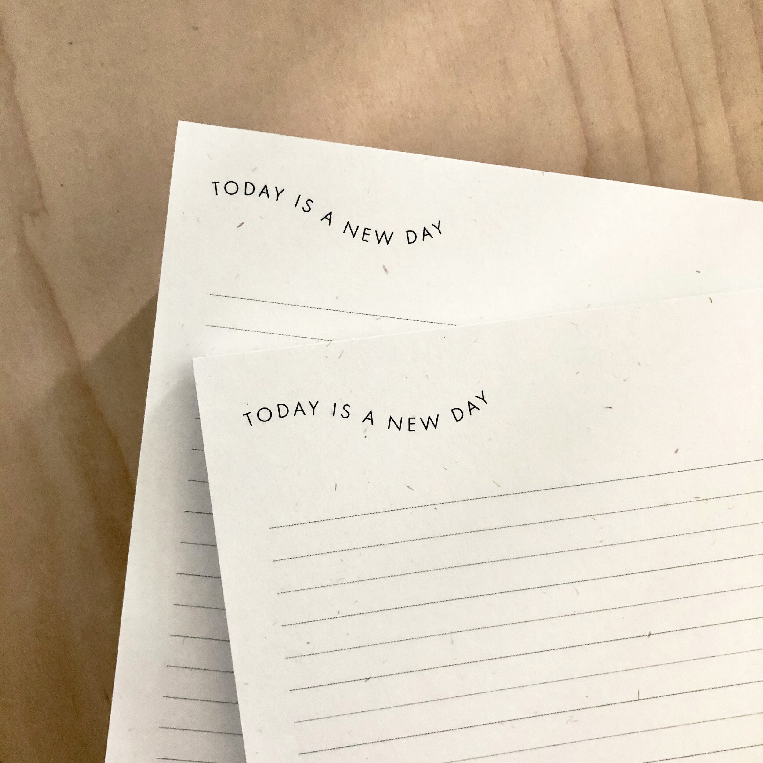 notepads on a wood desktop