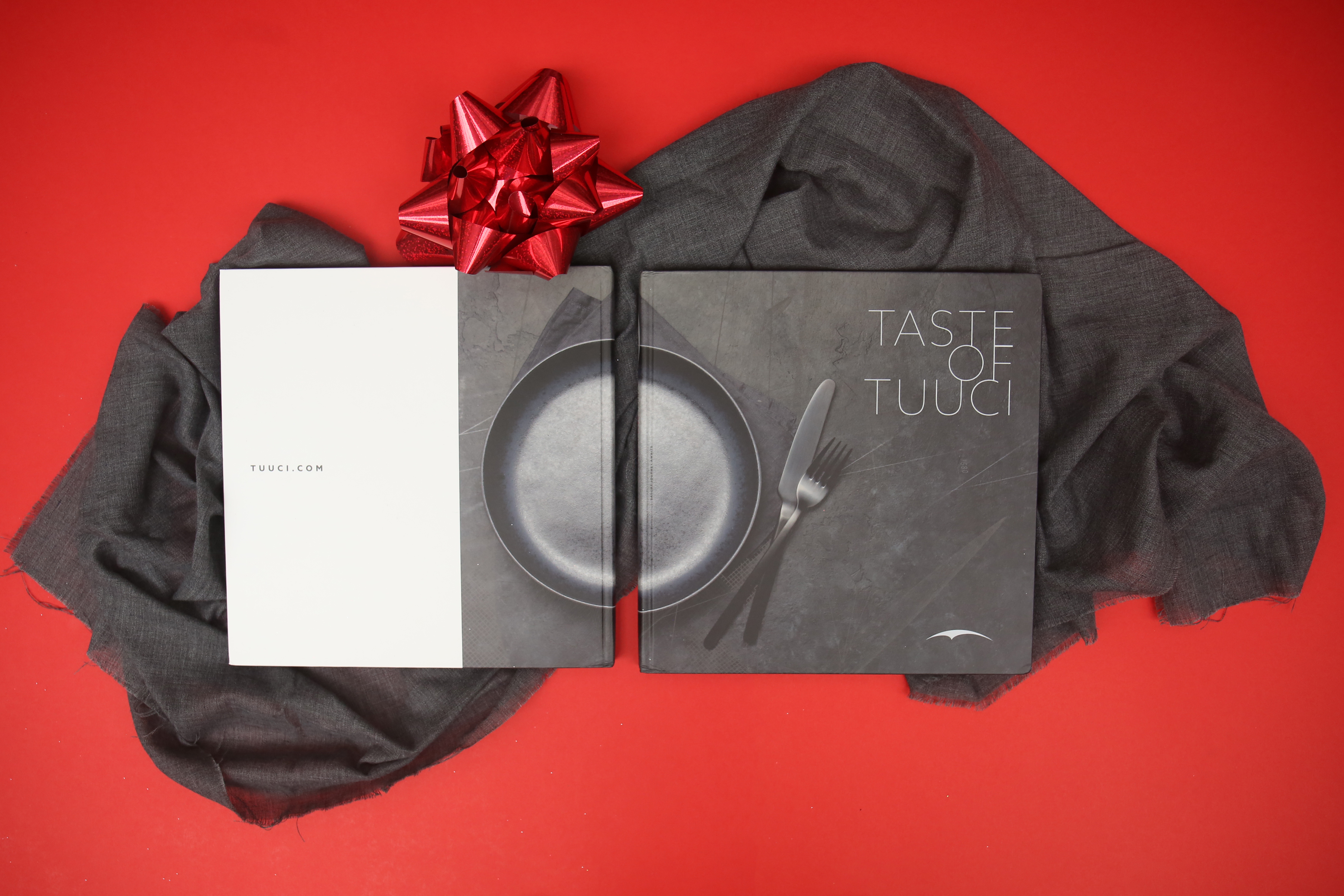 the front and back of the cookbook on a red background with a bow