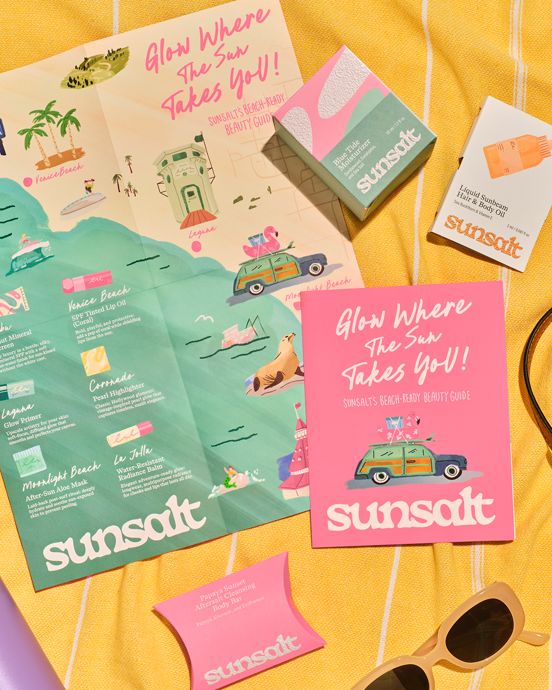 Sunsalt packaging spread out on beach blanket