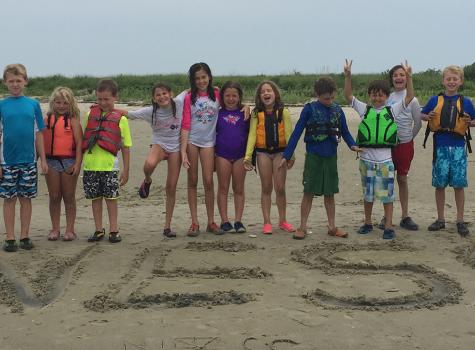 A picture of New England Science & Sailing members on a beach