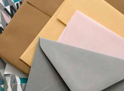 Close-up of a stack of envelopes in various sizes and colors