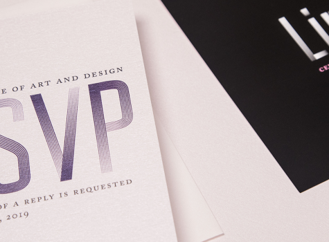 Close-up of RSVP card laying next to an invitation